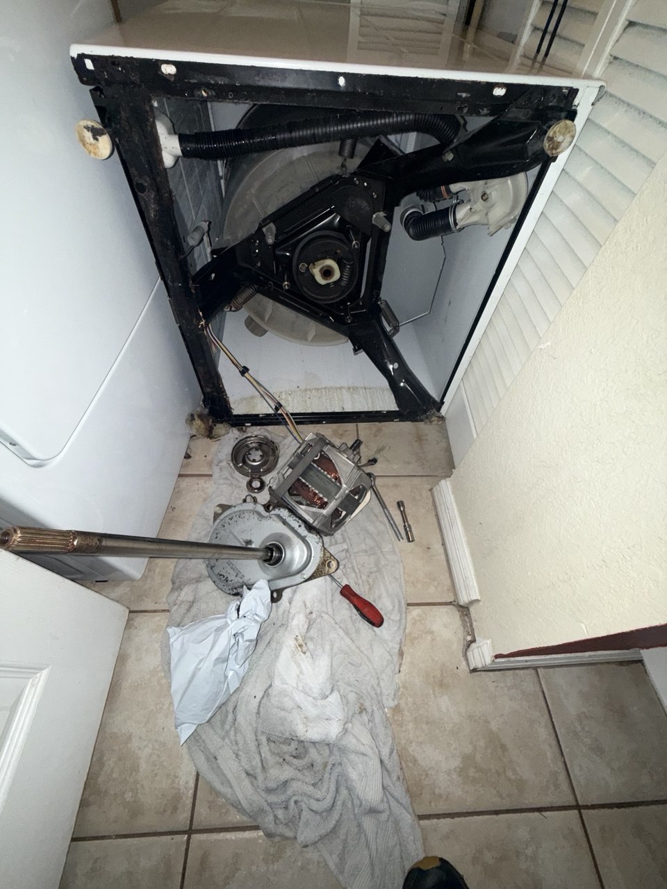 Washer repair in progress in a Naples home