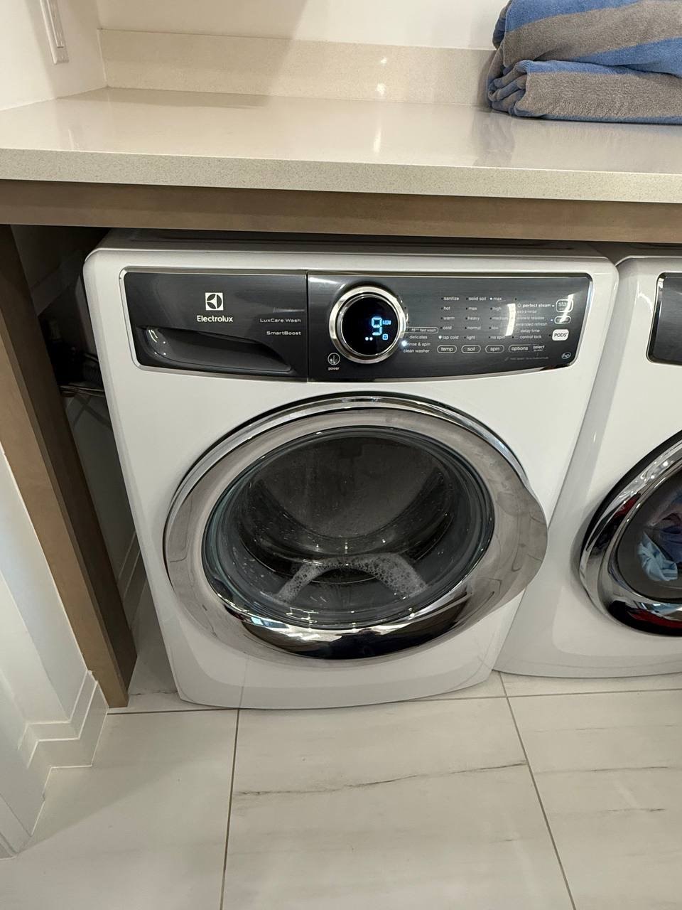 Washer repair in progress in a Naples home
