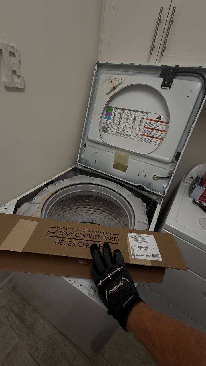 Technician completing a Whirlpool washer suspension repair